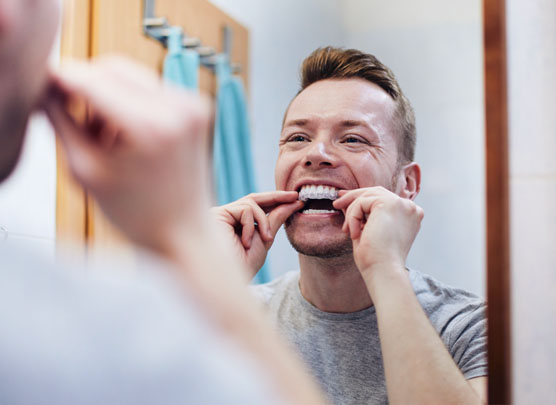 Man inserting dental appliance